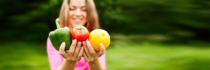 Image of a woman holding vegetables