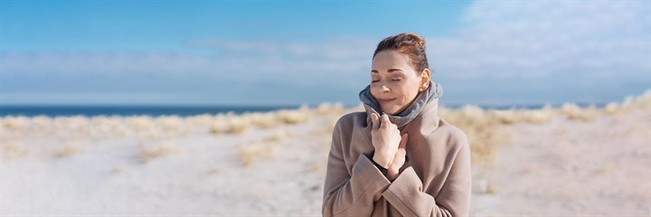 Woman enjoying the winter sun on a beach