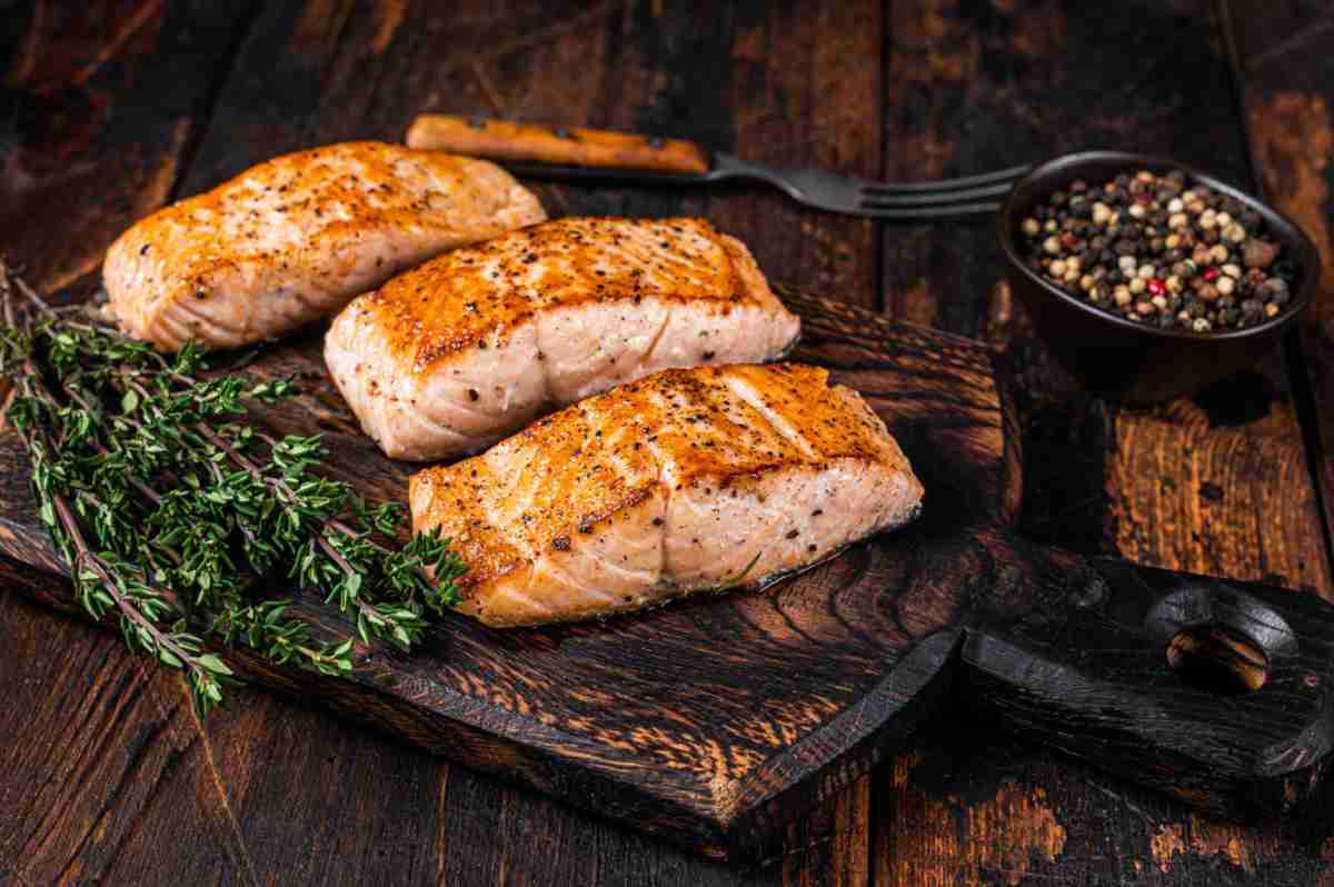 Cooked salmon on a wooden board